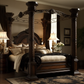 Four-poster bedframe with intricate carvings and a deep cherry finish. 